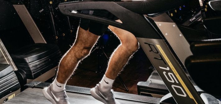 Topless Woman in Black Shorts and Brown Boots Sitting on Black Exercise Equipment